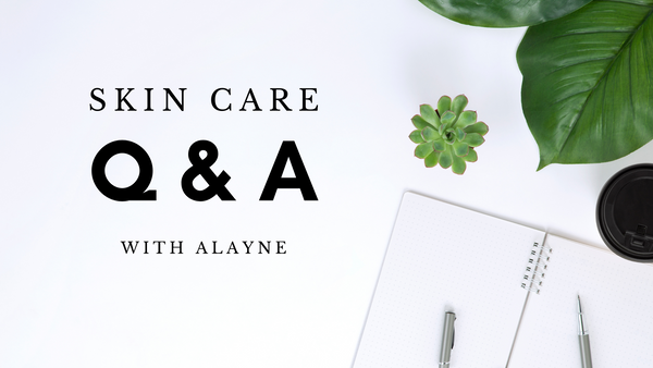 Blank background with the text "Skincare Q & A with Alayne". Large leaf and succulent in top corner, notebook with a pen and a coffe cup in bottom corner.