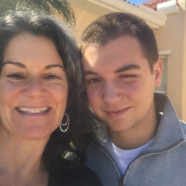 mom smiling next to her son who is smiling