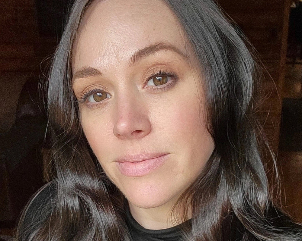 Close-up of a person with long, wavy hair indoors.